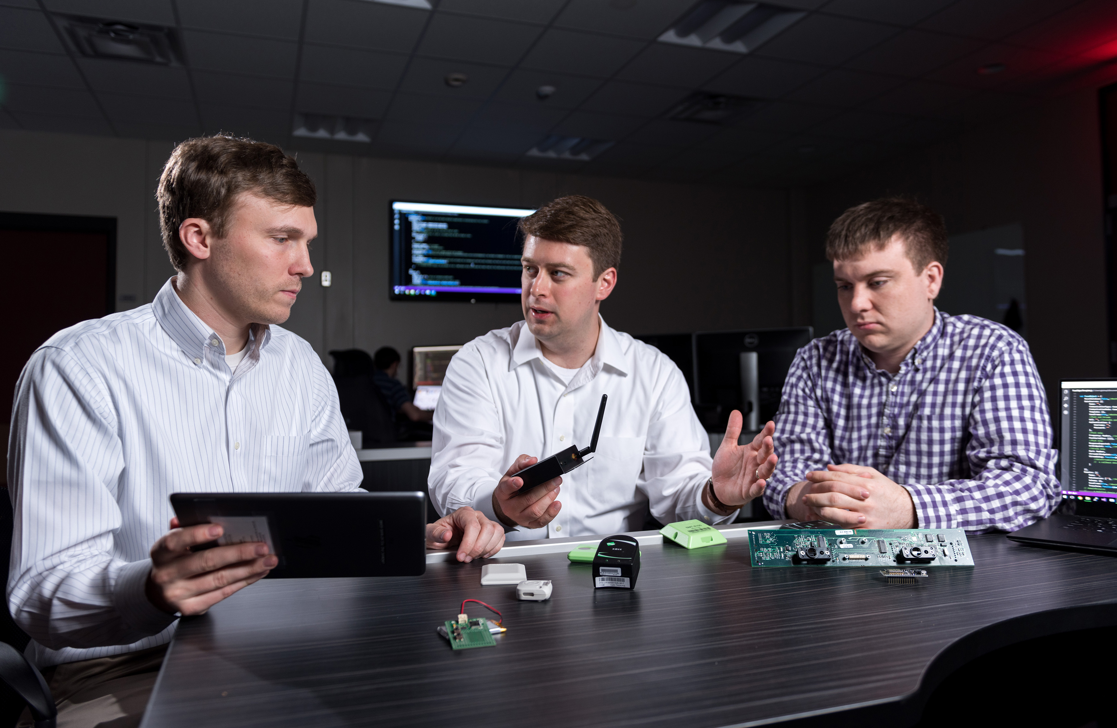 three researchers with internet of things devices