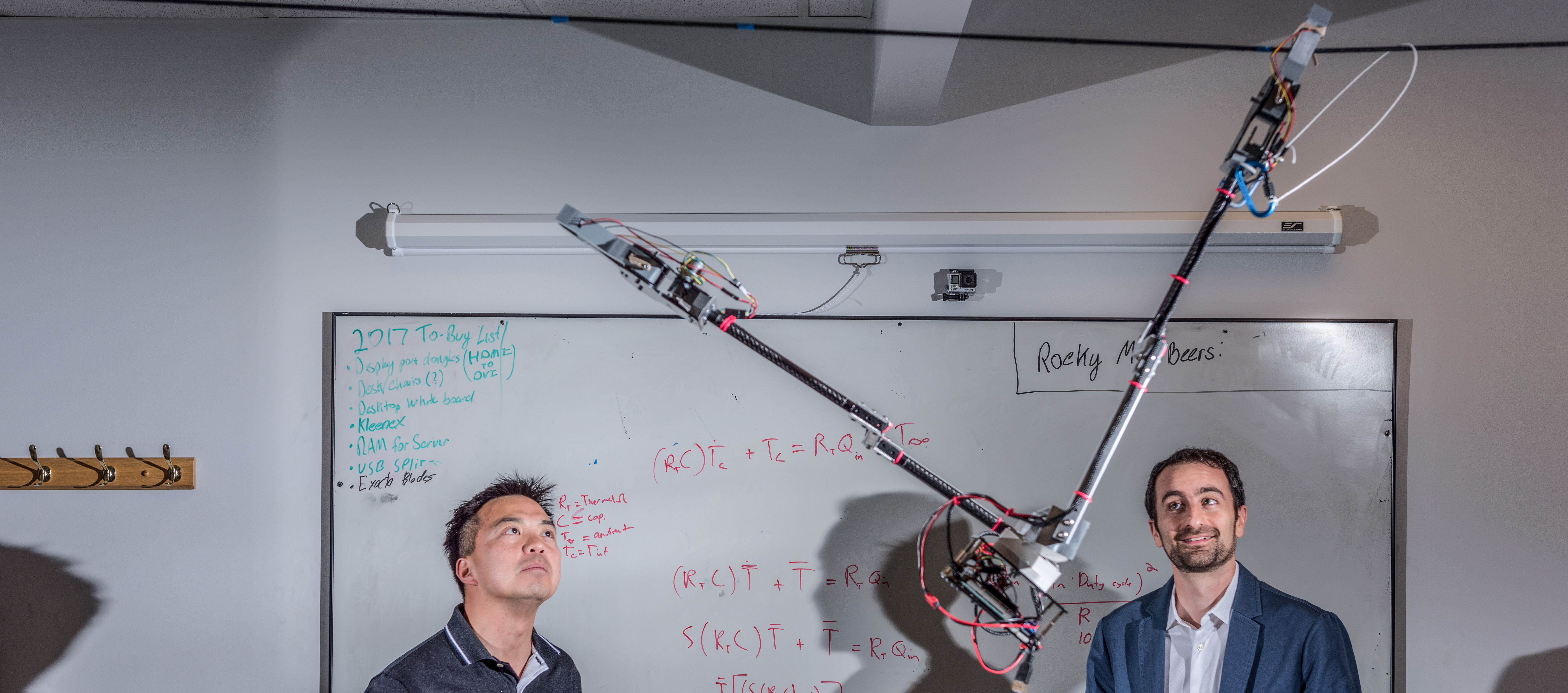 Researchers Jonathan Rogers and Ai-Ping Hu are shown with the Tarzan robot in Georgia Tech Research Institute Lab