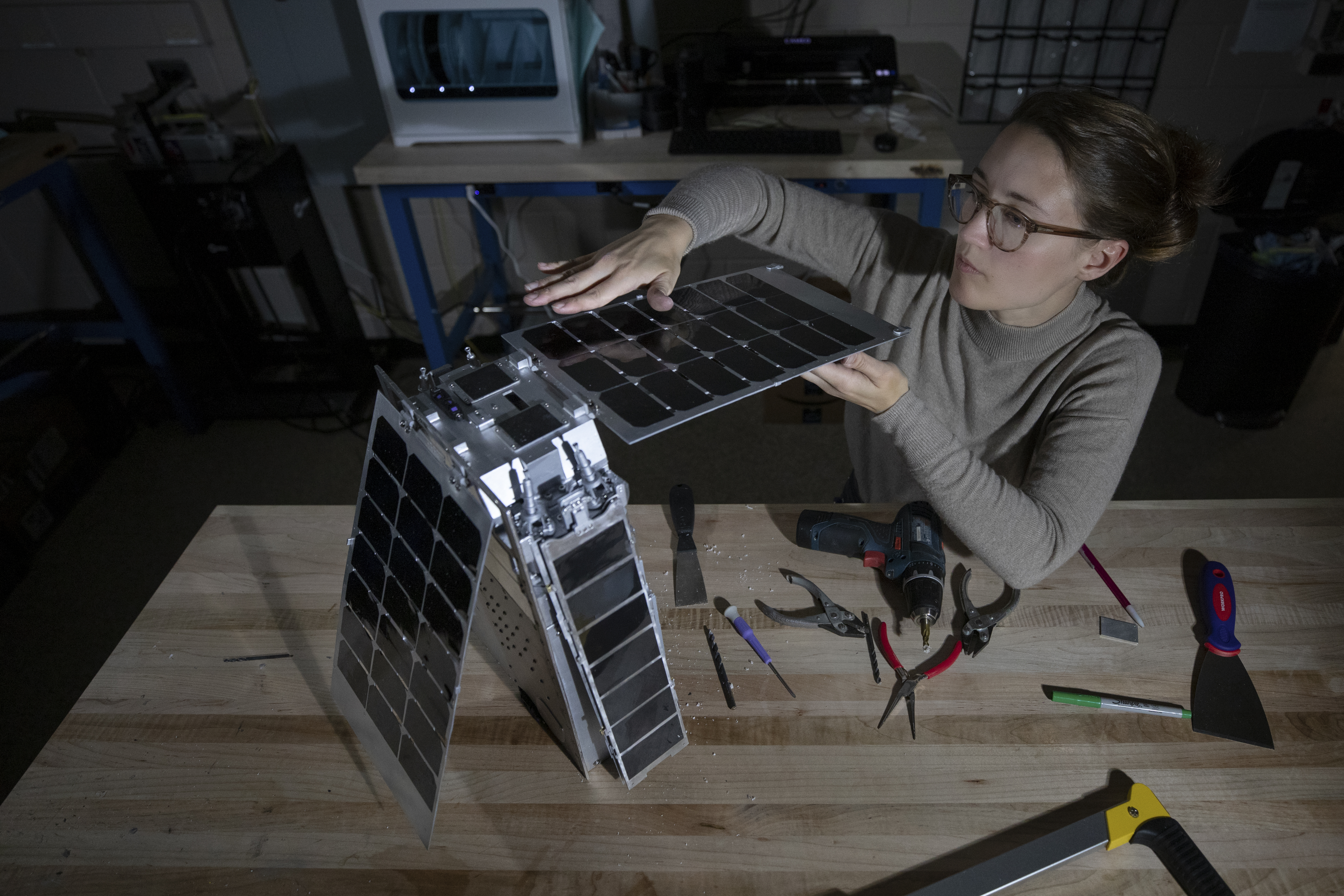 GTRI student assistant Mary Kate Broadway makes final adjustments to Lunar Flashlight model in the SEEDLab makerspace