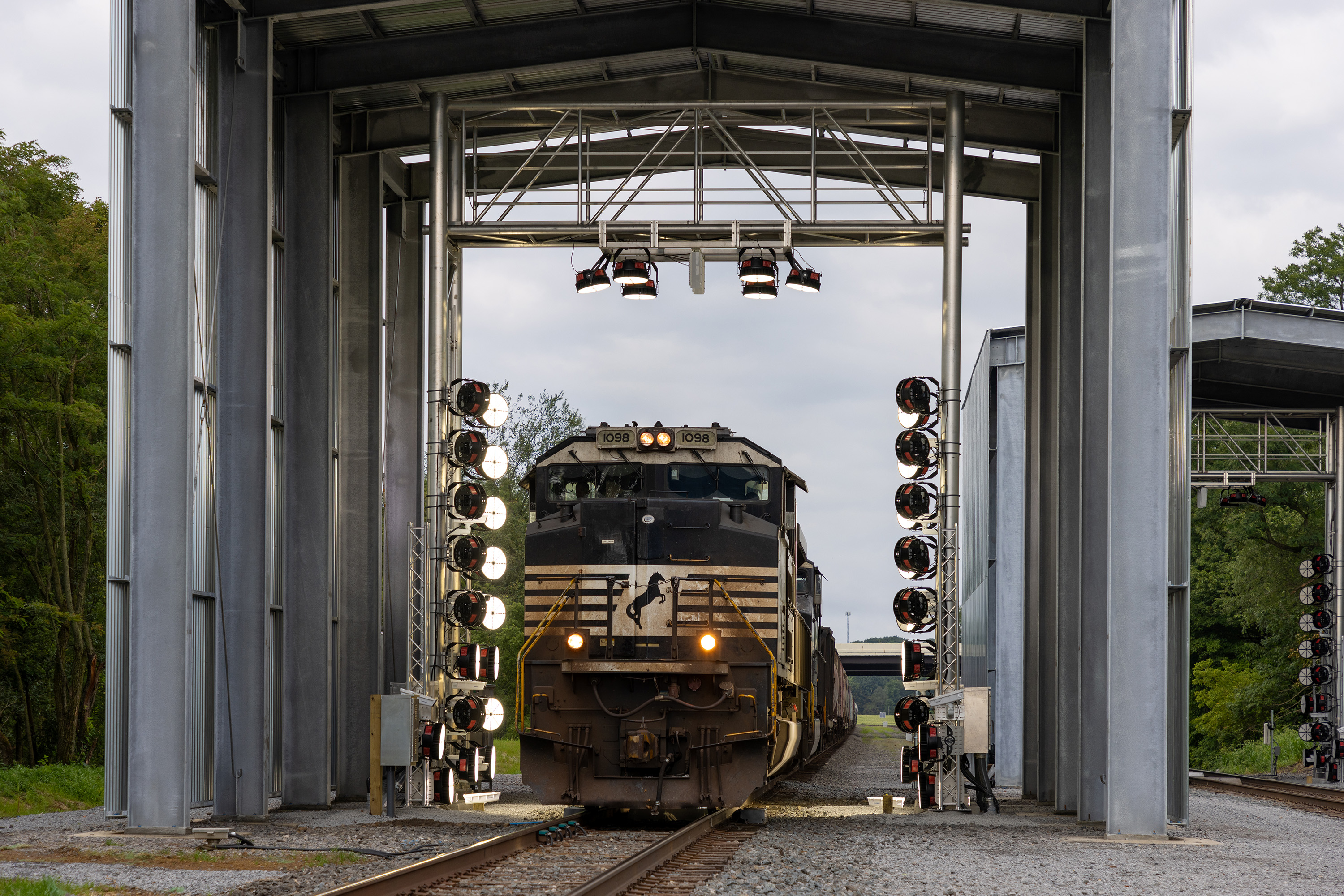 Photo of train inside metal portal structure.