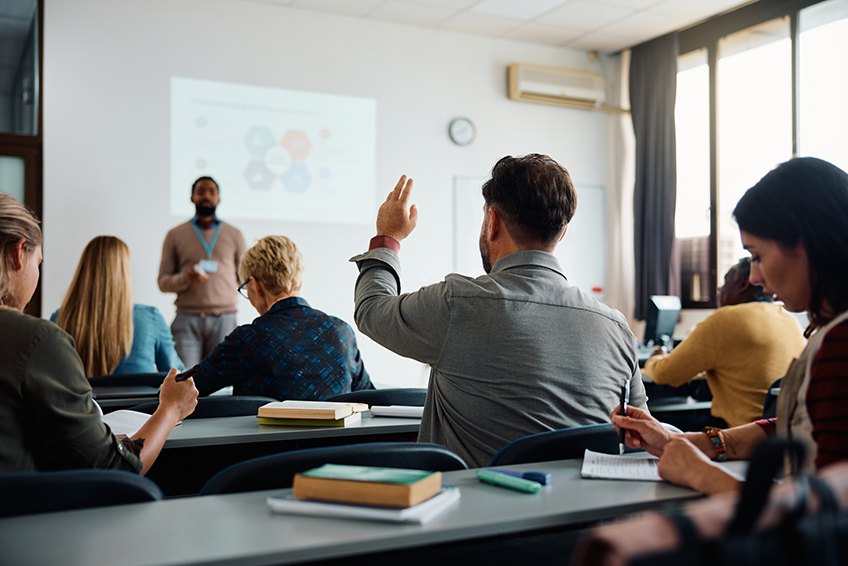 Stock image of a classroom with students and a teacher.  