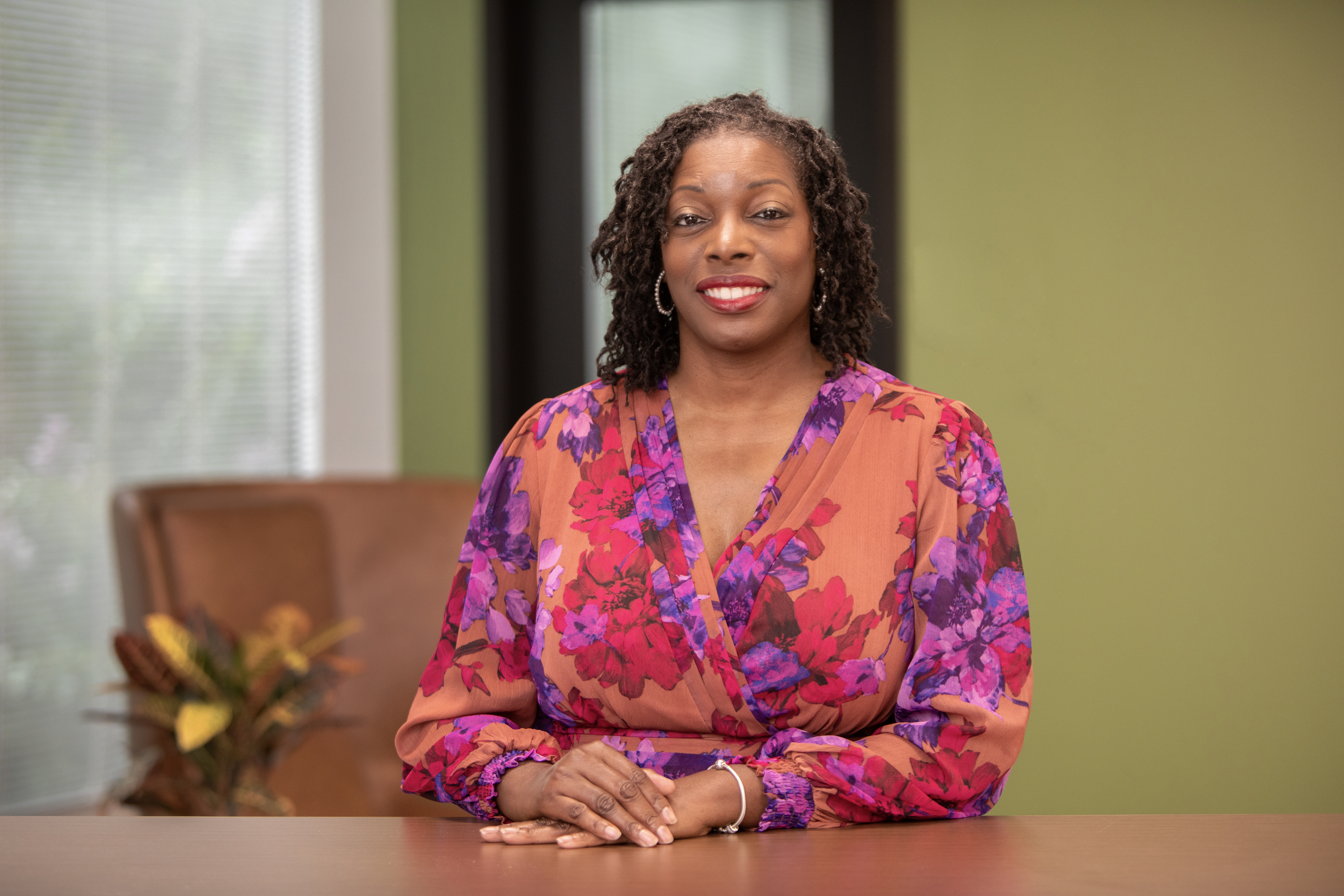 Renee Gourdine at an office and sitting at a desk. (Photo: Christopher Moore)