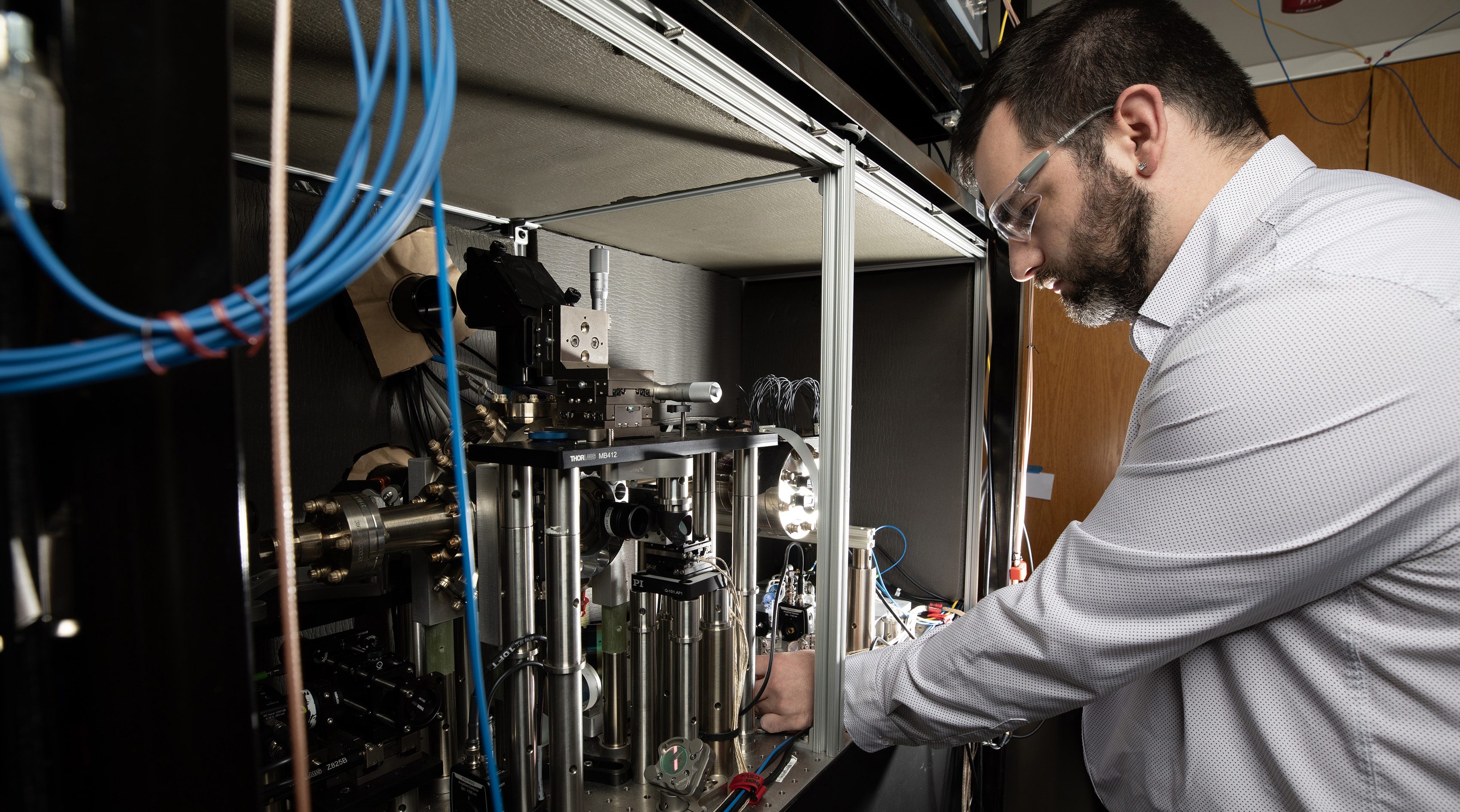 Researcher adjusts equipment for studying quantum simulations