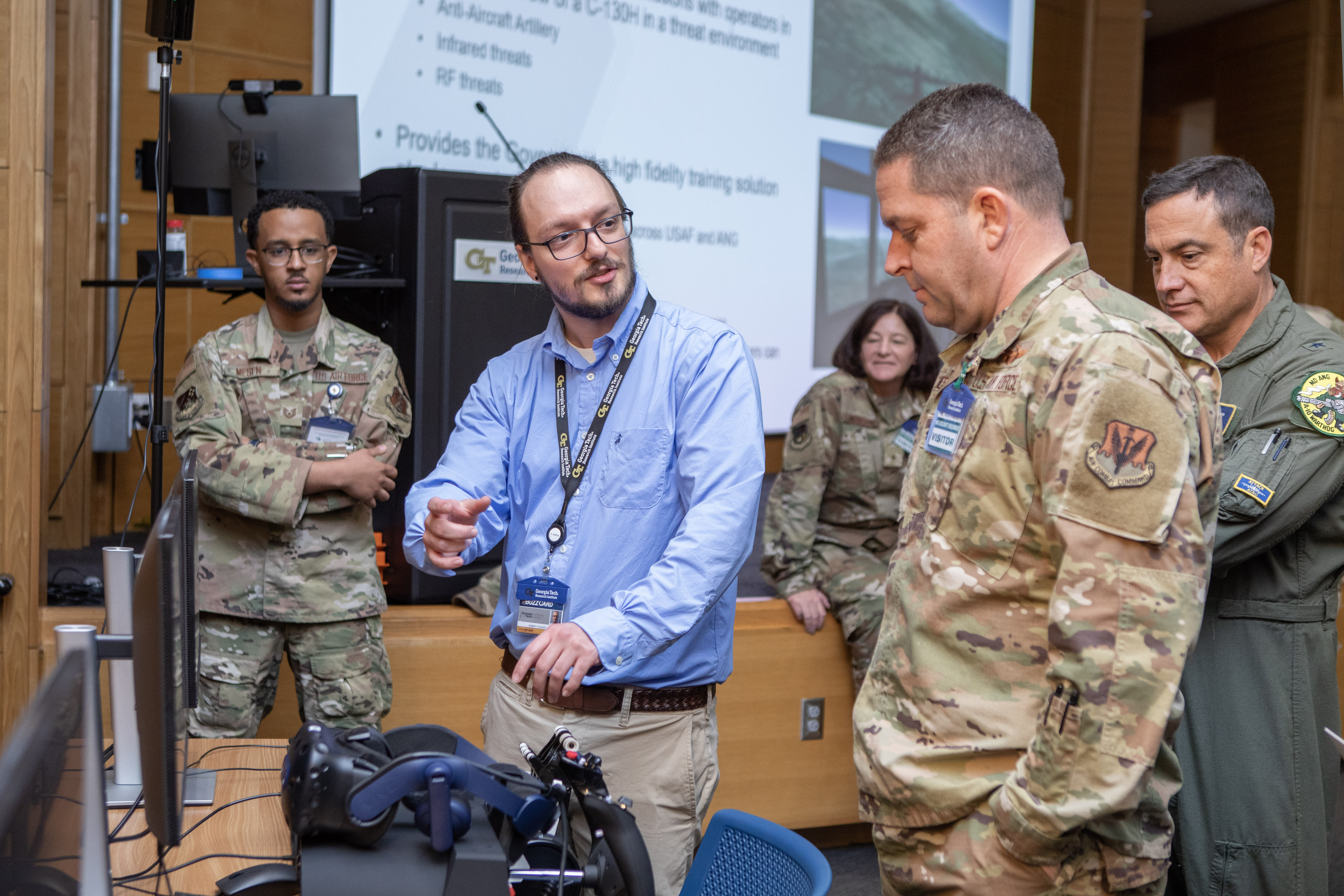 Engineer and soldiers in uniform looking at technology