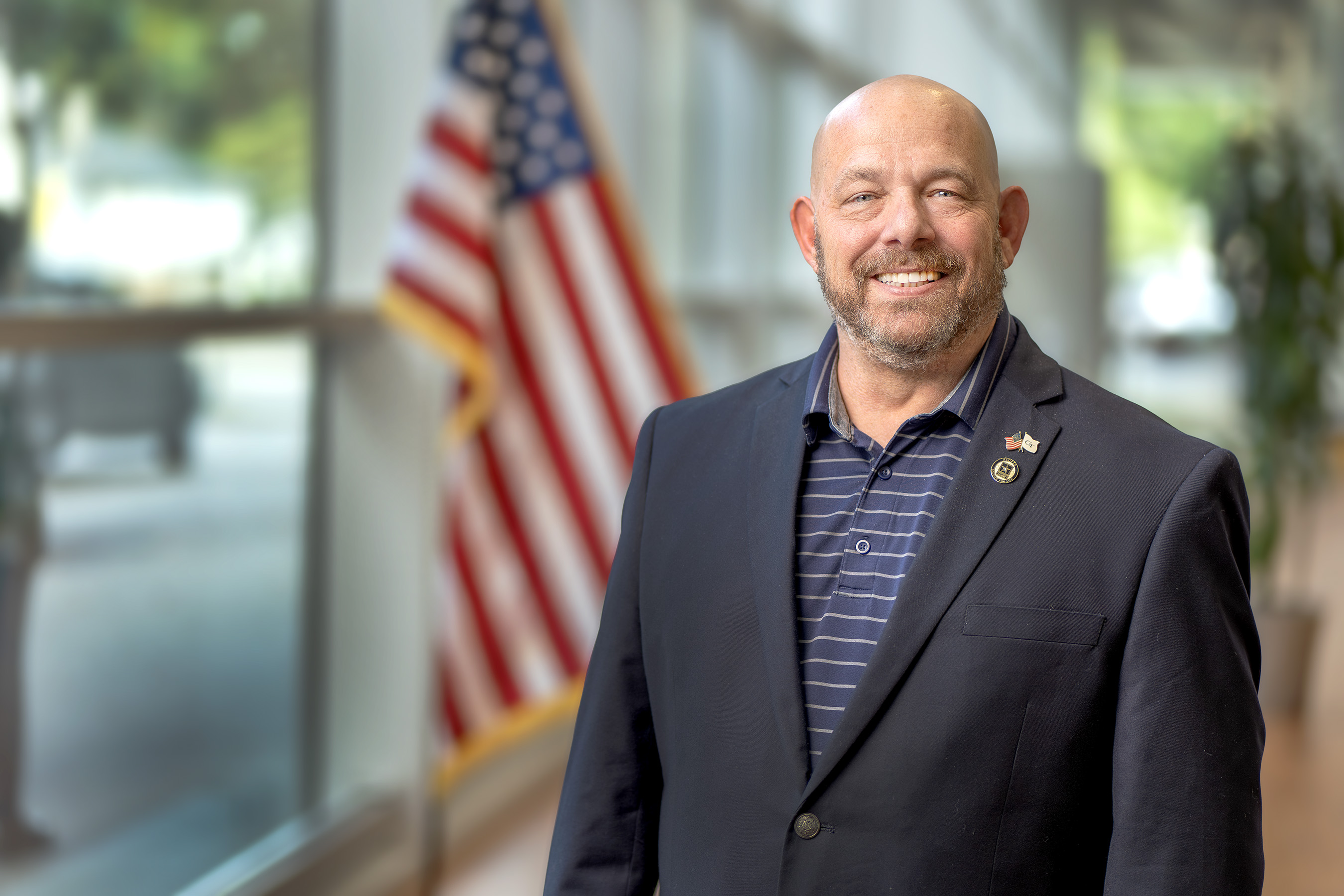 GTRI employee standing in front of American flag