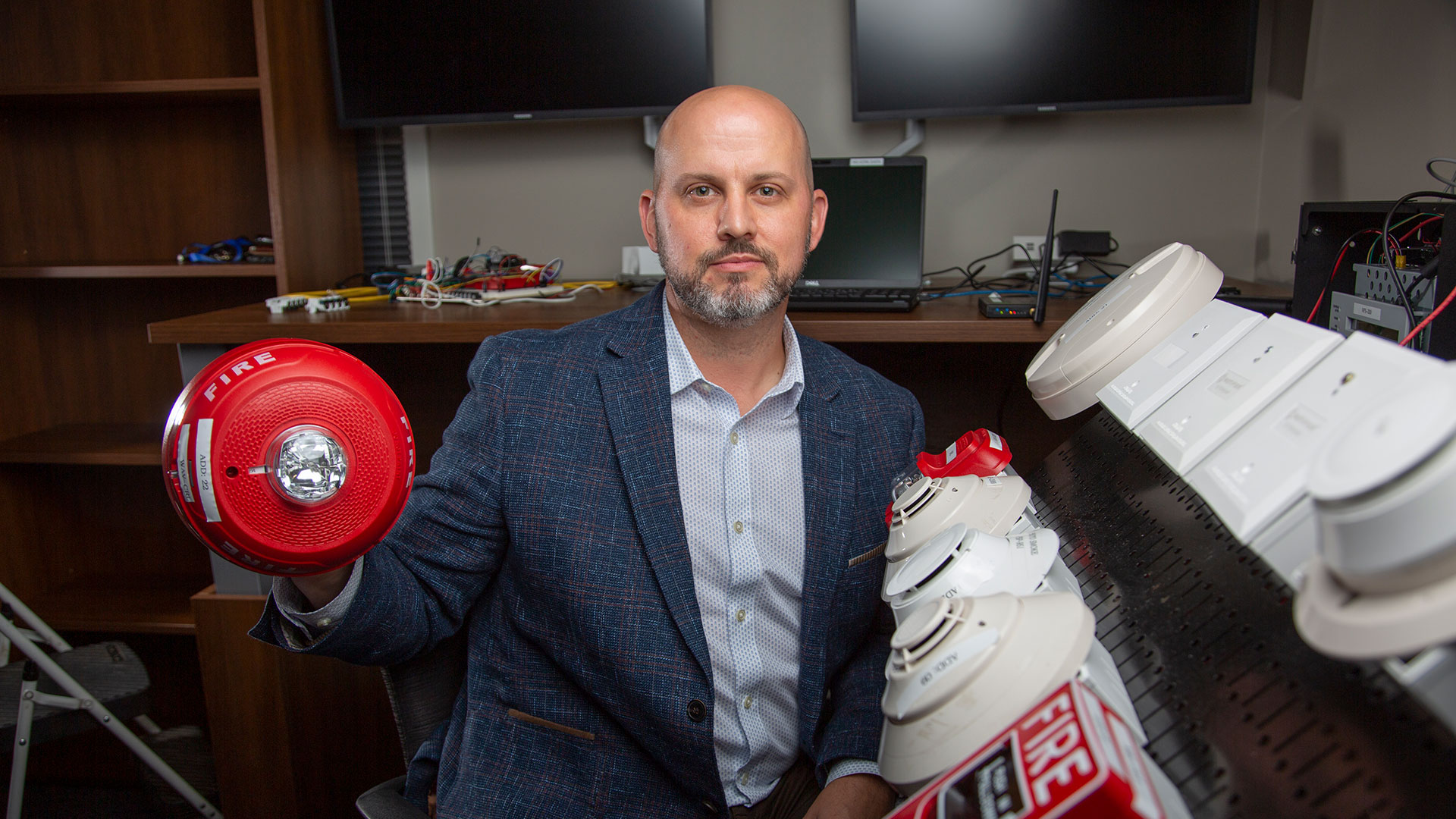Chris Roberts, a GTRI principal research engineer and lead instructor for the Embedded Systems Cybersecurity (ESCS) VIP class, is currently teaching a course on fire alarms. Roberts and his students are deconstructing fire alarms and figuring out ways to protect the systems against potential cyber threats (Credit: Christopher Moore, GTRI)