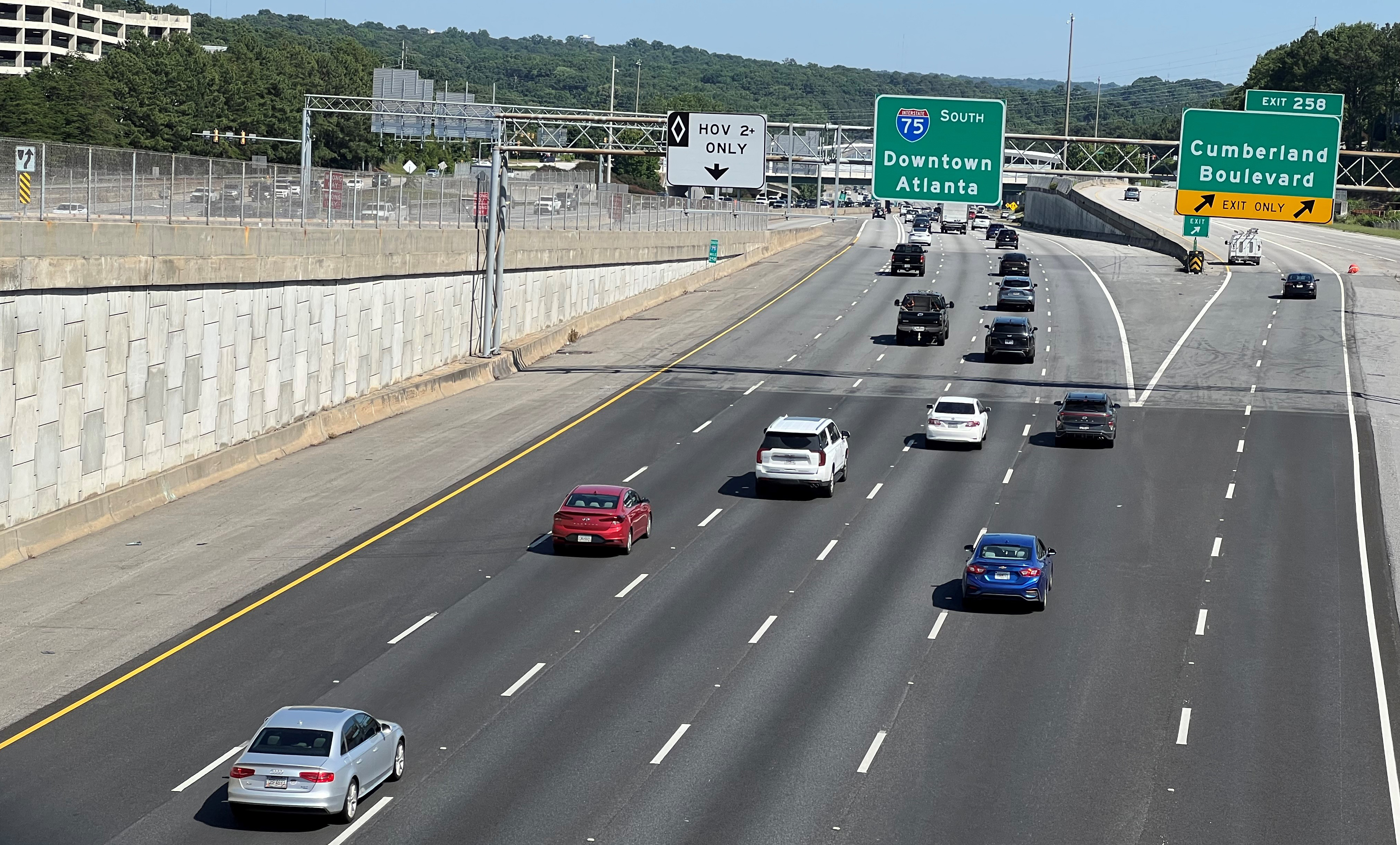 Southbound traffic moving on Interstate 75 in Cobb County. An entrance ramp for the high-occupancy vehicle lane is in the background.