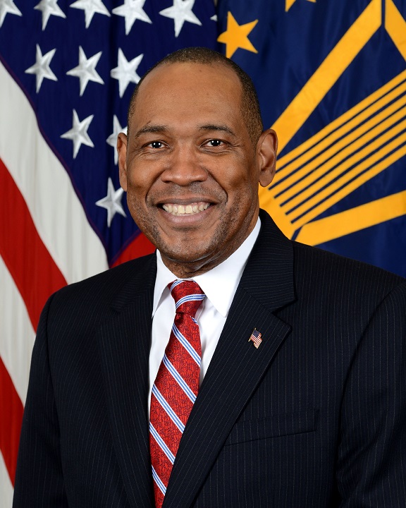 Troy Littles portrait in front of flag