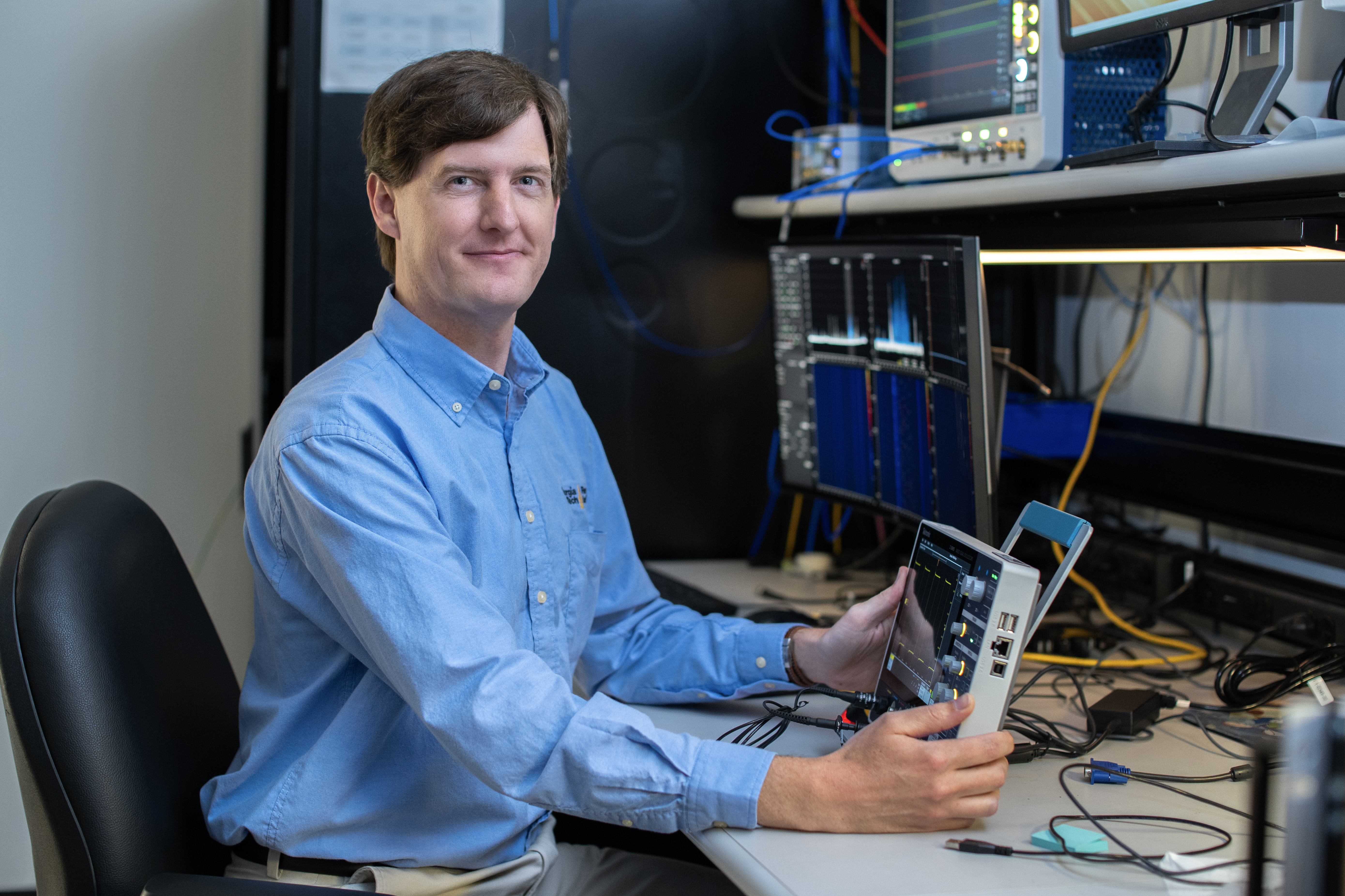 Photo of researcher Ryan Bales sitting at a desk. Photo Credit: Christopher Moore