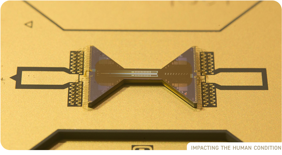 photo: close up of gold computer chip. Appears to be in the shape of a bowtie.