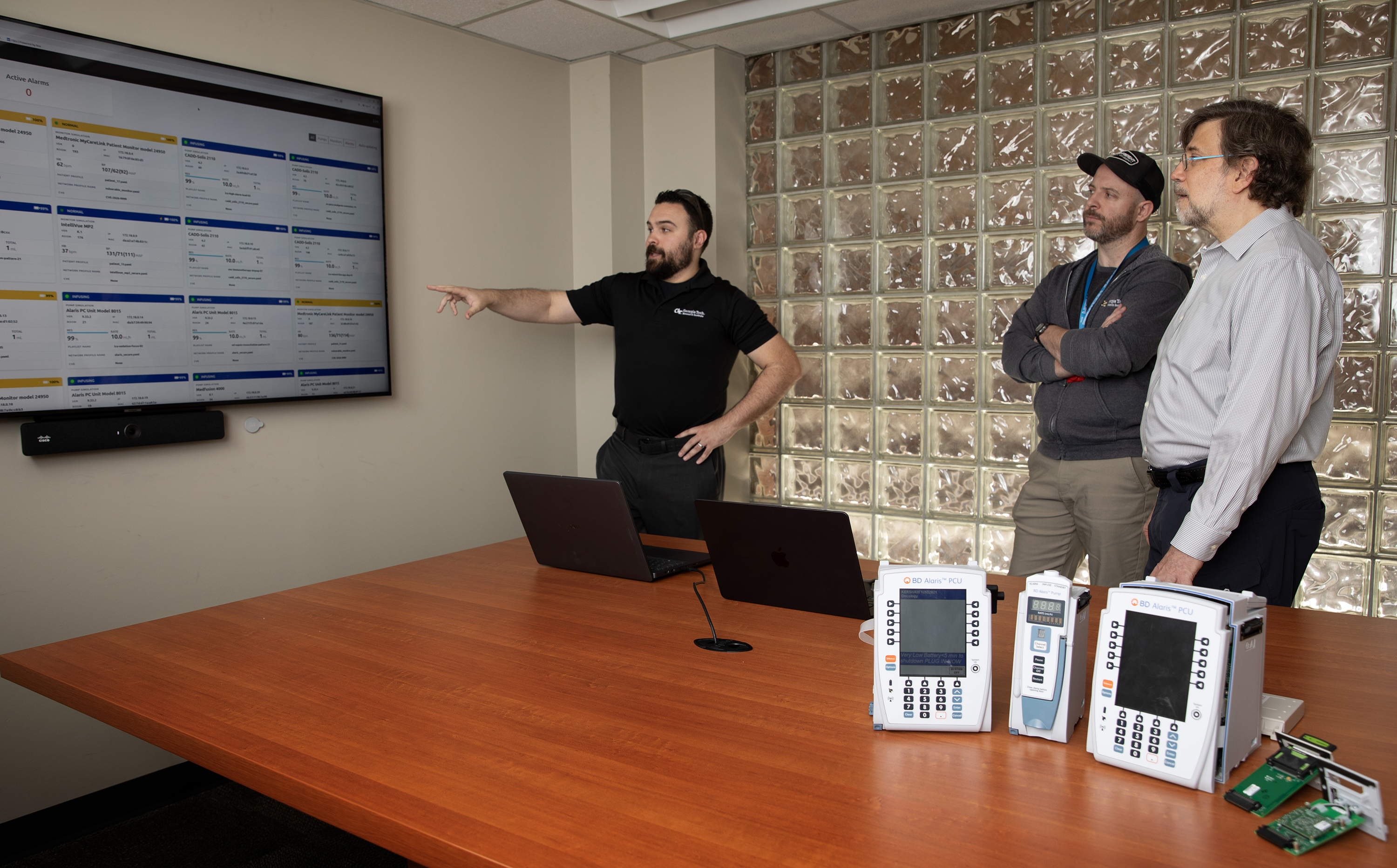 Researchers discuss a display showing device status