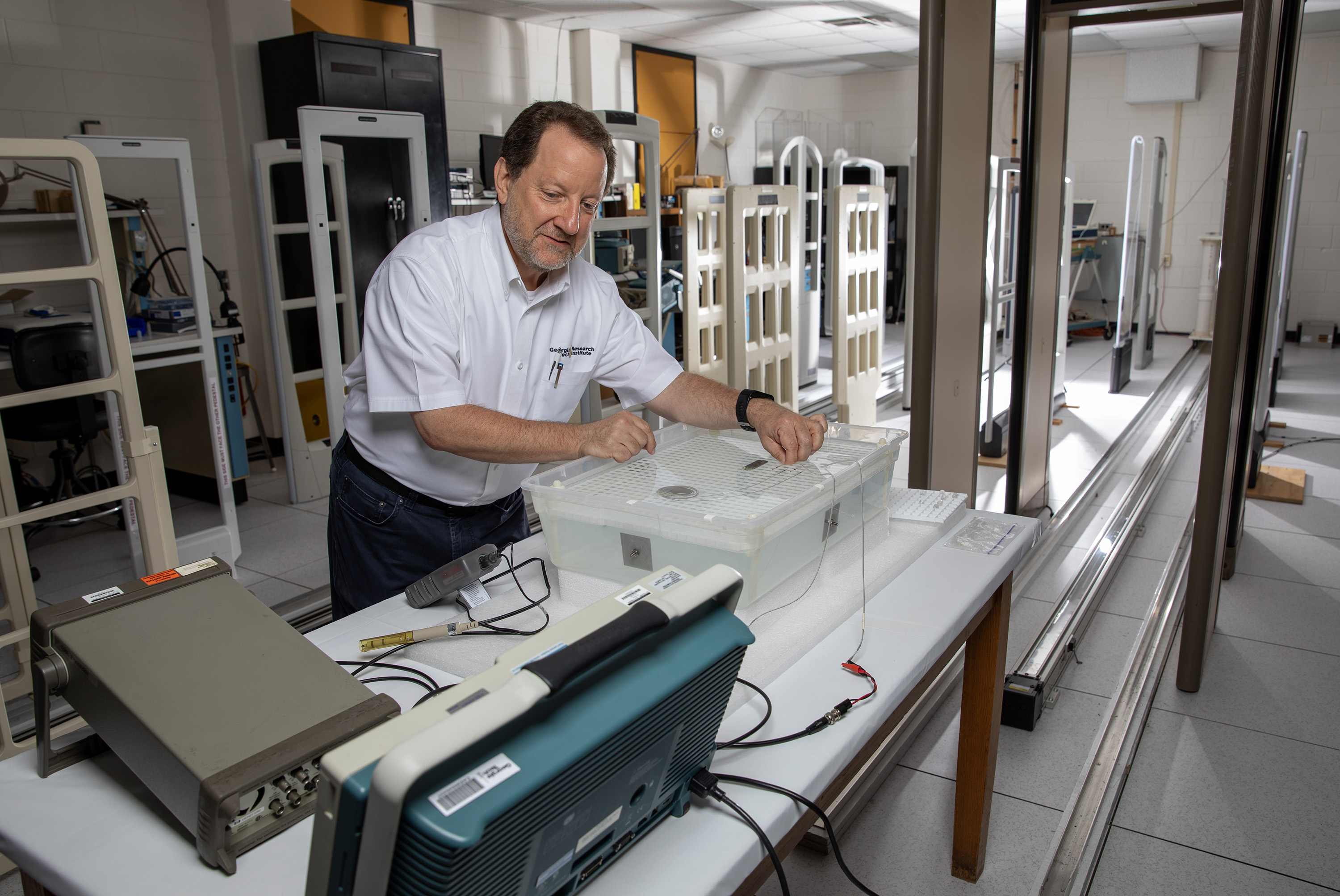 Researcher tests two medical devices in a tank of saline solution.