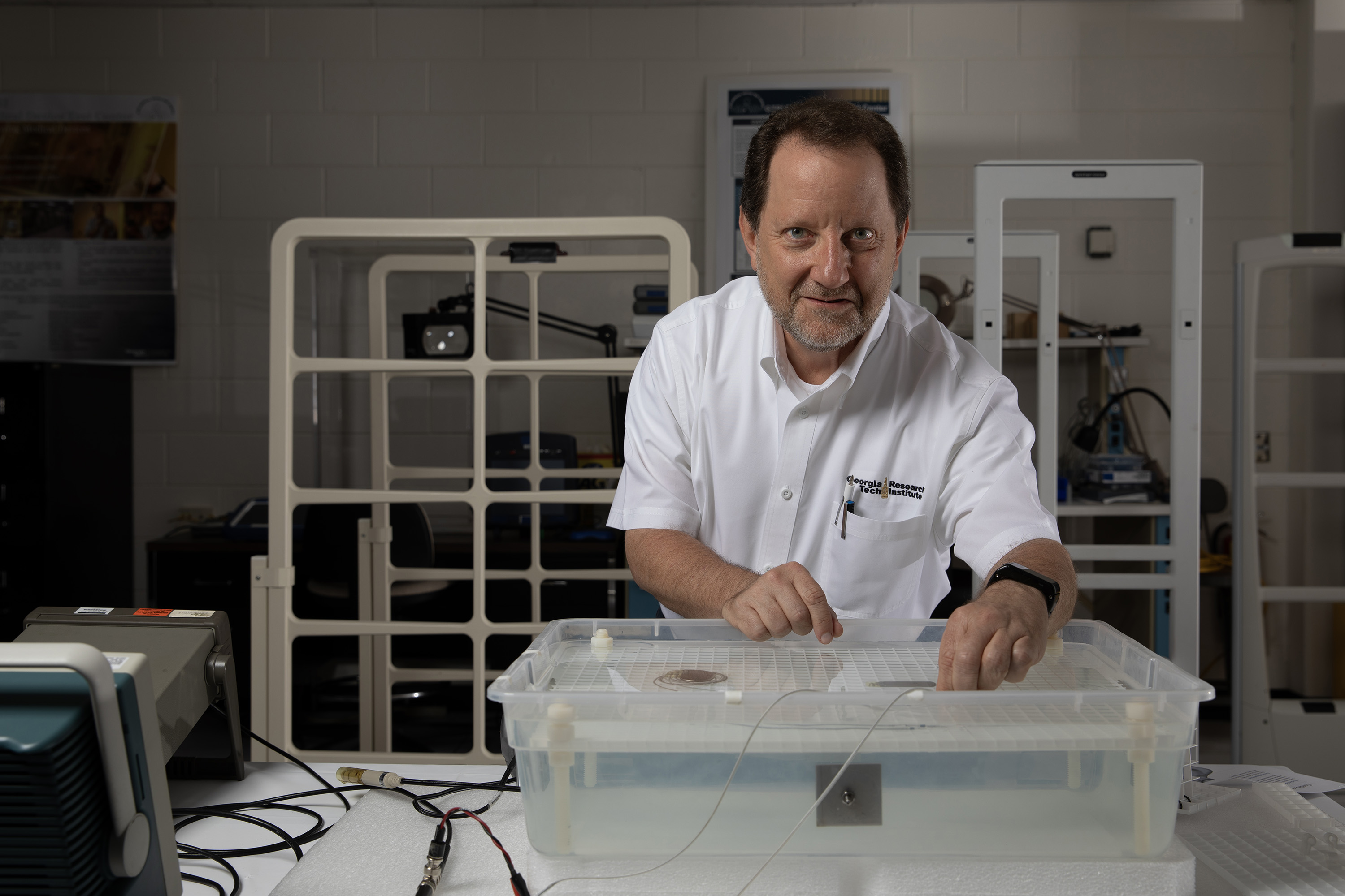 Researcher tests two medical devices in a tank of saline solution.