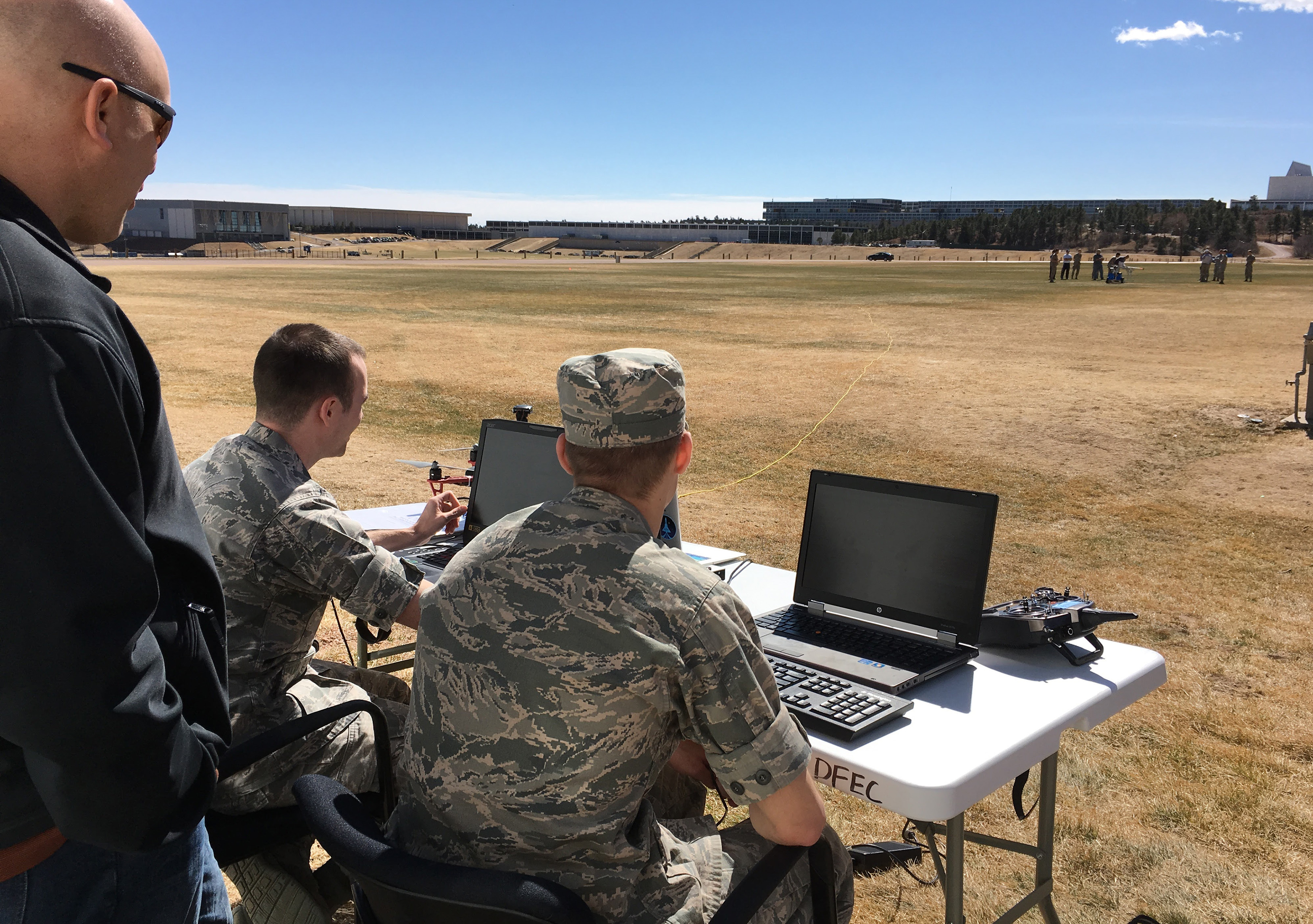 Service academy team members monitor the competition from the ground. (Credit: DARPA)
