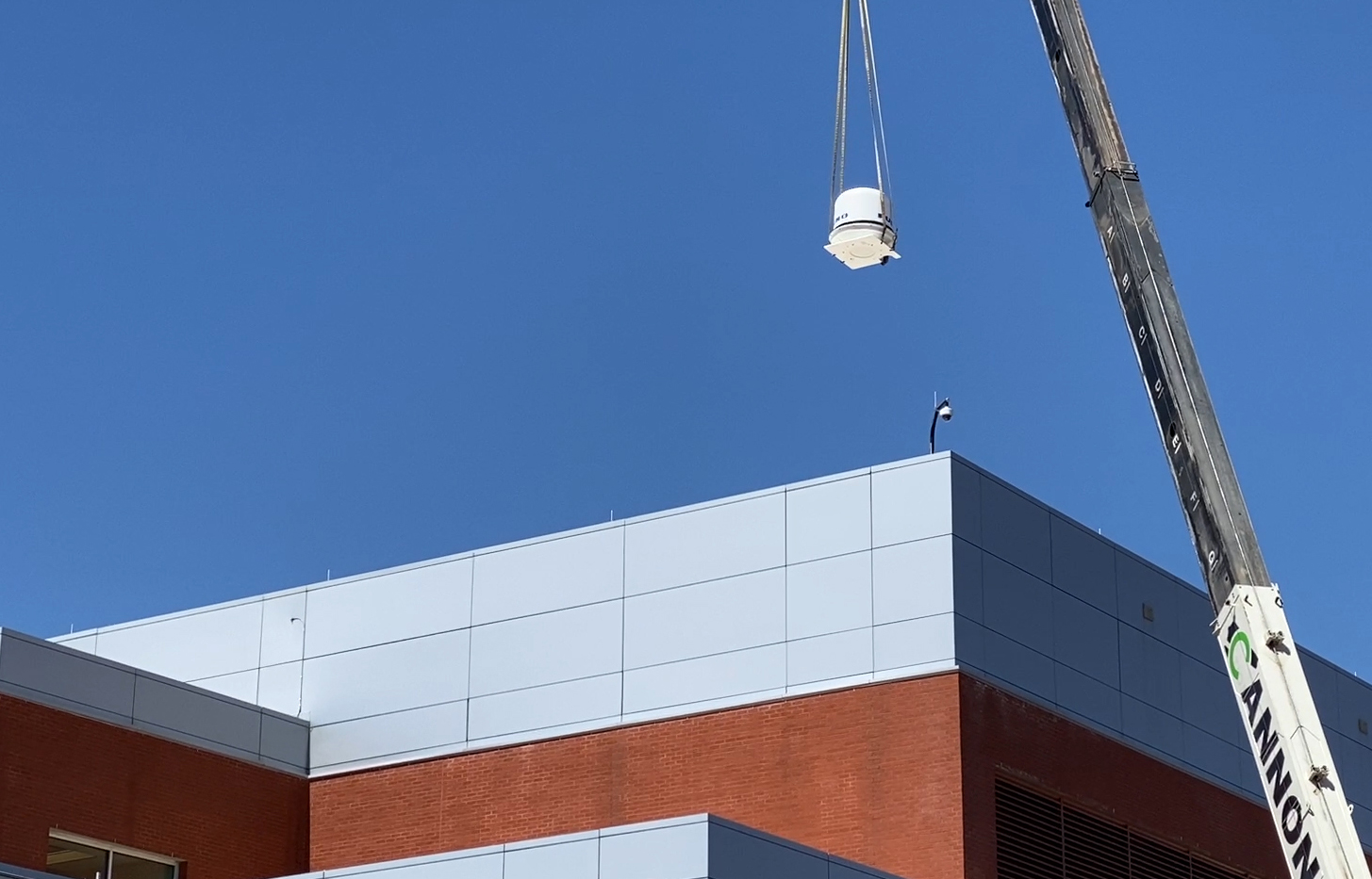 The weather radar being hoisted onto the roof at Georgia Gwinnett College