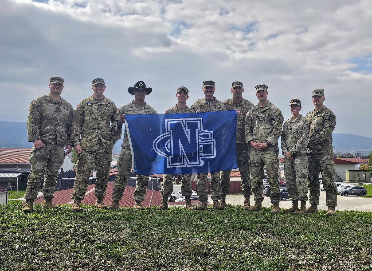 Keegan George poses with fellow soldiers who graduated from the University of North Georgia.(left to right): SPC Tommy Hall, CPT Garrett Floyd, CPT Nick Blanks, CPT Brandon Mooney, 1LT Keegan George, MAJ Alan Schmitz, 1LT Thomas Kirby, CPT Andreana Chebat, CPT Andrew Medina. Taken at Camp Novo Selo, Kosovo during George's deployment.