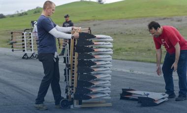 GTRI researchers with stack of UAVs