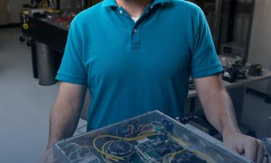 Researcher with fiber optic prototype