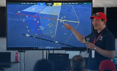 Timothy Chung, the DARPA program manager leading the research effort, briefs teams about the competition. (Credit: DARPA)