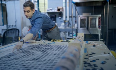 Ilan Stern, a GTRI senior research scientist, shows how piezoelectric tiles are produced. The tiles will be used to create a lighted outdoor footpath at the NASA Kennedy Space Center’s Visitor Complex at Cape Canaveral. (Credit: Branden Camp, Georgia Tech Research Institute)