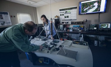 John-Trostel-director-of-the-Severe-Storms-Research-Center-SSRC-and-Madeline-Frank-a-research-meteorologist-at-the-SSRC-examine-equipment-for-the-North-Georgia-Lightning-Mapping-Array