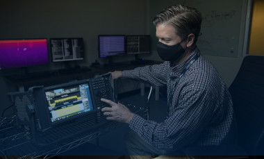 Photo of a GTRI researcher conducting lab research. 