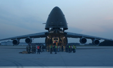 Photo taken at dusk shows components of the ARTS-V1 system loaded into a C-5M Super Galaxy aircraft.