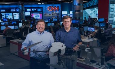 Shown in CNN’s World Headquarters are (left) Greg Agvent, senior director of news operations for CNN, and Cliff Eckert, a GTRI senior research associate. They are working with an AirRobot AR 180 (Credit: Rob Felt, Georgia Tech)