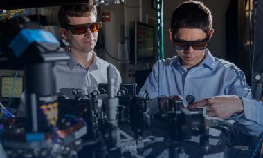 GTRI scientists work in an optical lab developing improved ion traps that could be used in quantum computing. Shown, from left, are research scientists Jason Amini and Nicholas Guise. (Credit: Rob Felt)