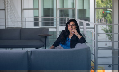 Gayatri Shah, a senior research engineer at Georgia Tech Research Institute's (GTRI) Project Management Support Office (PMSO), sits on a couch in the Coda building. (Credit: Branden Camp) 