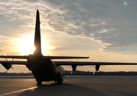 photo - C130J aircraft on the ground in silhouette with sunset