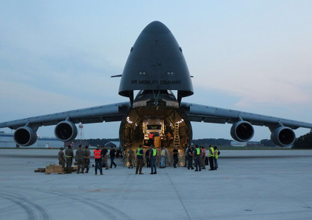 Photo taken at dusk shows components of the ARTS-V1 system loaded into a C-5M Super Galaxy aircraft.