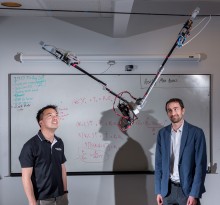 Researchers Jonathan Rogers and Ai-Ping Hu are shown with the Tarzan robot in Georgia Tech Research Institute Lab