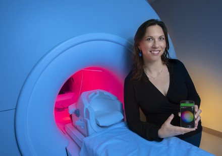 GTRI-Research-Associate-Megan-Denham-shows-a-smartphone-app-that-controls-lighting-around-an-MRI-simulator