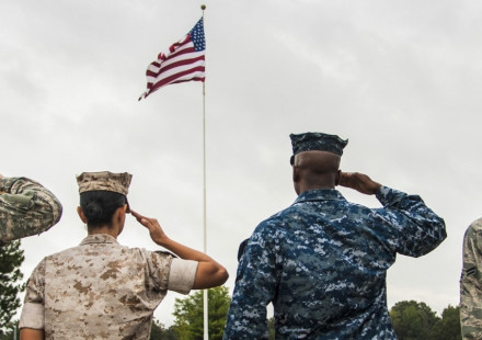 Soldiers saluting the American flag. 