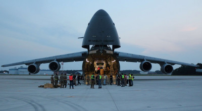 Photo taken at dusk shows components of the ARTS-V1 system loaded into a C-5M Super Galaxy aircraft.