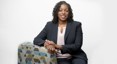 Photo of Black woman sitting in a chair.