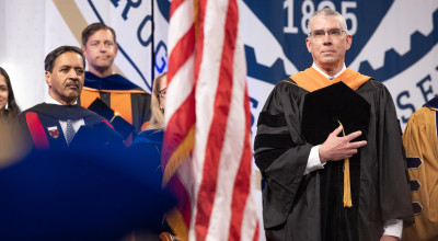 GTRI Director Mike Gazarik in academic regalia with hand over heart during Georgia Tech Spring 2026 commencement ceremony.
