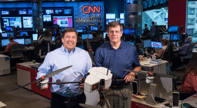 Shown in CNN’s World Headquarters are (left) Greg Agvent, senior director of news operations for CNN, and Cliff Eckert, a GTRI senior research associate. They are working with an AirRobot AR 180 (Credit: Rob Felt, Georgia Tech)