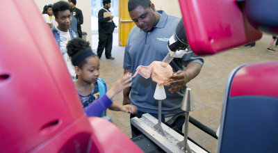 researcher with student using robot