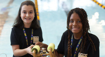 Two students pose with underwater robot