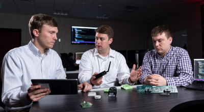 three researchers with internet of things devices