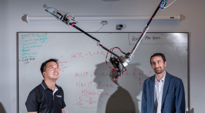 Researchers Jonathan Rogers and Ai-Ping Hu are shown with the Tarzan robot in Georgia Tech Research Institute Lab