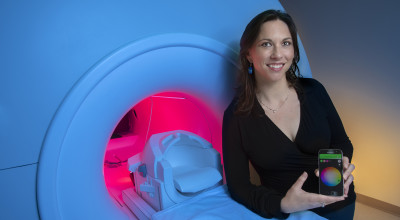 GTRI-Research-Associate-Megan-Denham-shows-a-smartphone-app-that-controls-lighting-around-an-MRI-simulator