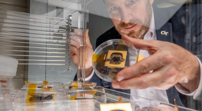 GTRI-Principal-Research-Engineer-Jud-Ready-holds-a-sample-of-a-perovskite-solar-cell-along-with-other-samples-similar-to-those-launched-to-the-International-Space-Station.