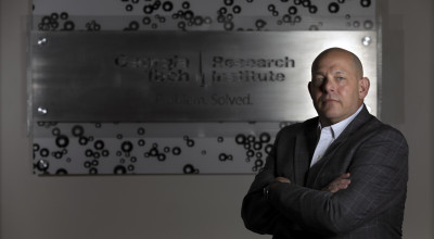 Erik Andersen standing in front of a GTRI sign.
