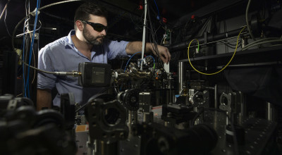 Researcher checks alignment of Doppler cooling beam