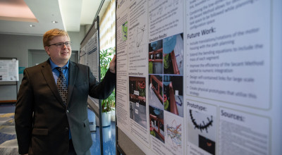 Konrad Ahlin with poster at DARPA Forward conference