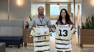 Rafa Dominguez donates rugby uniforms to Joshua Kinoshita.