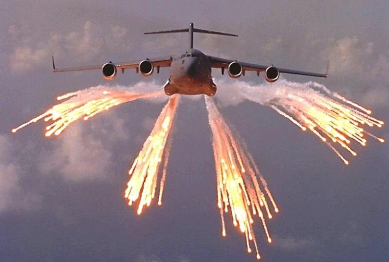 Big plane with flares coming out of wings